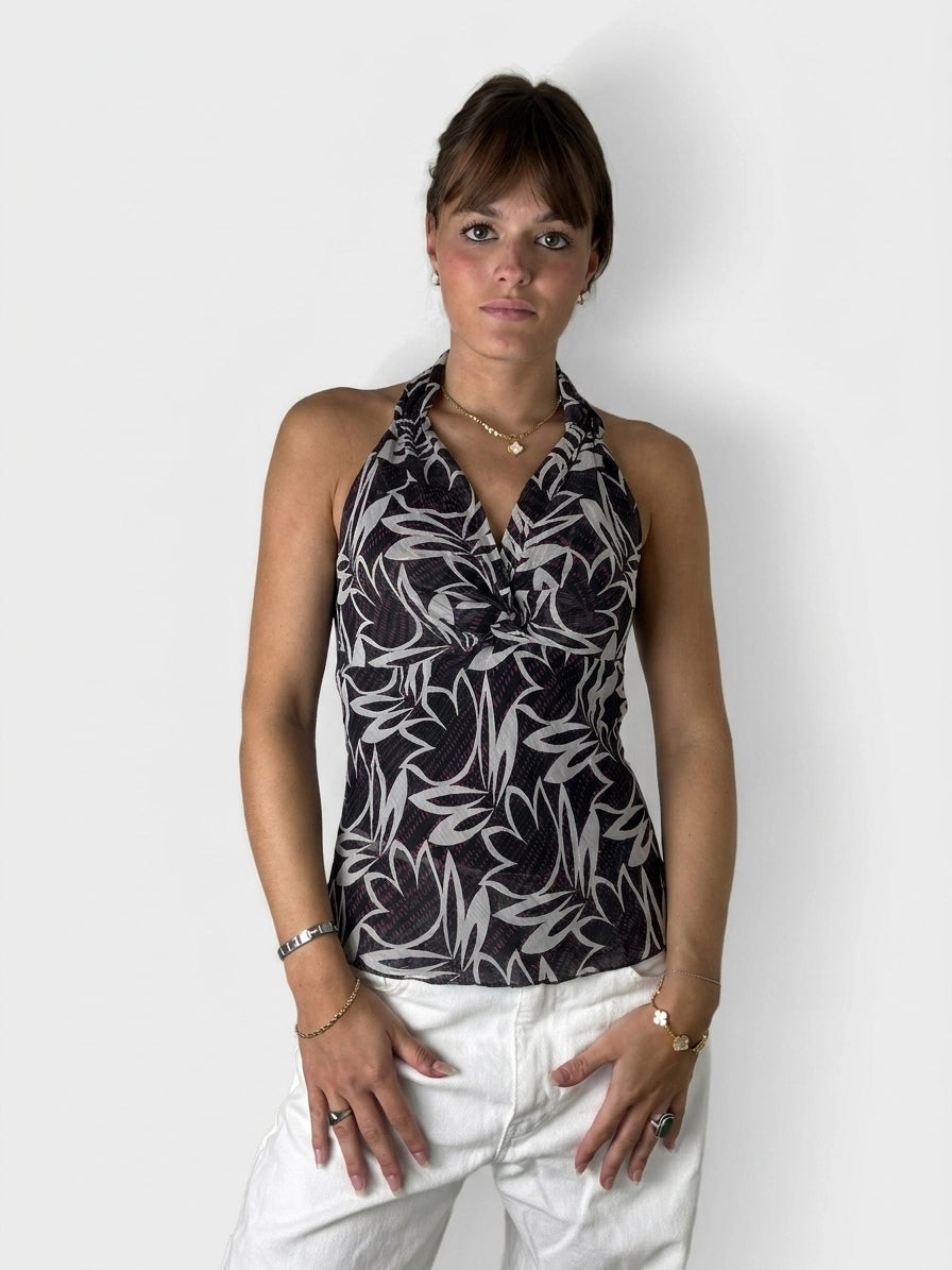 Front view of a sleeveless black and white floral print top.