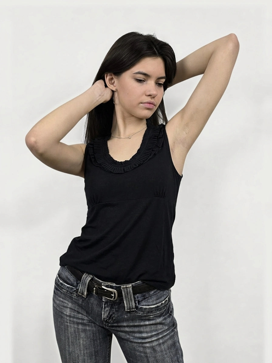 Black sleeveless top with ruffled neckline, front view.