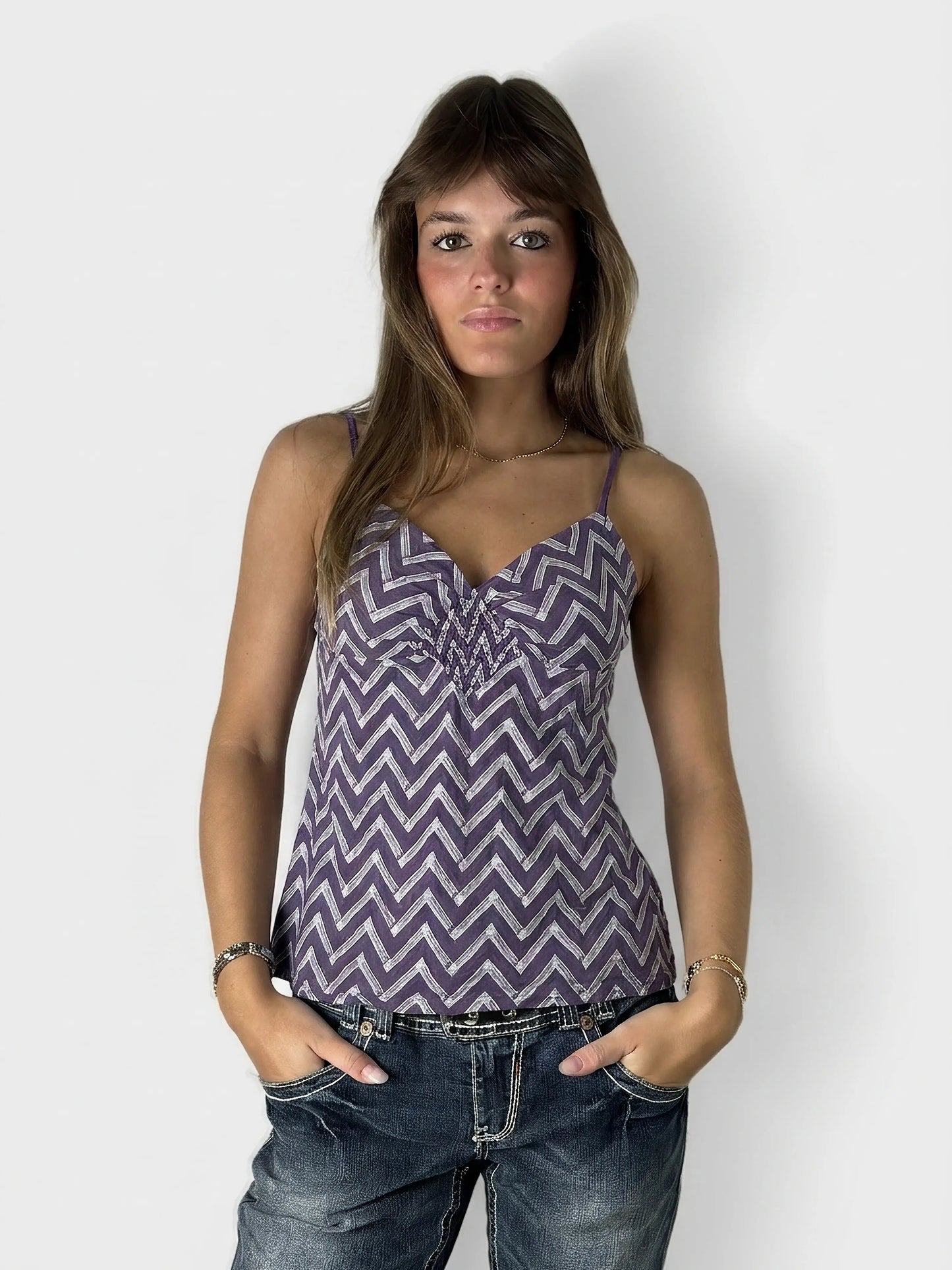 Front view of a women's purple chevron-patterned top with spaghetti straps.