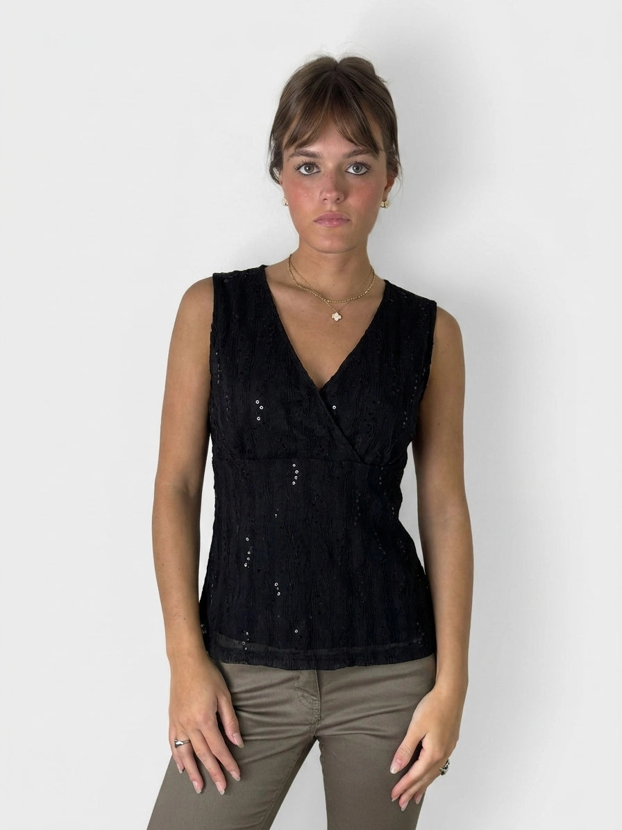 Black wrap top with a textured pattern, front view.
