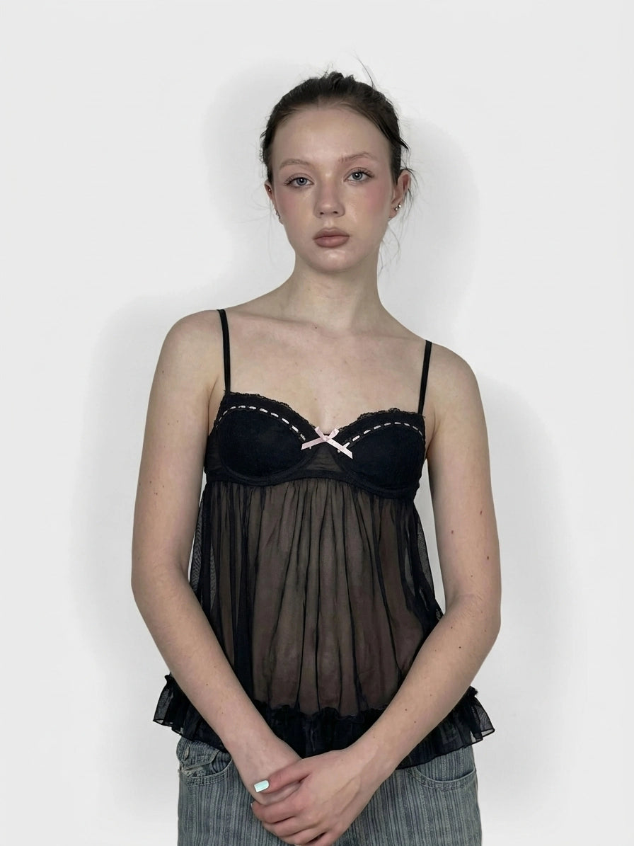 Black sheer top with pink trim and lace, front view.
