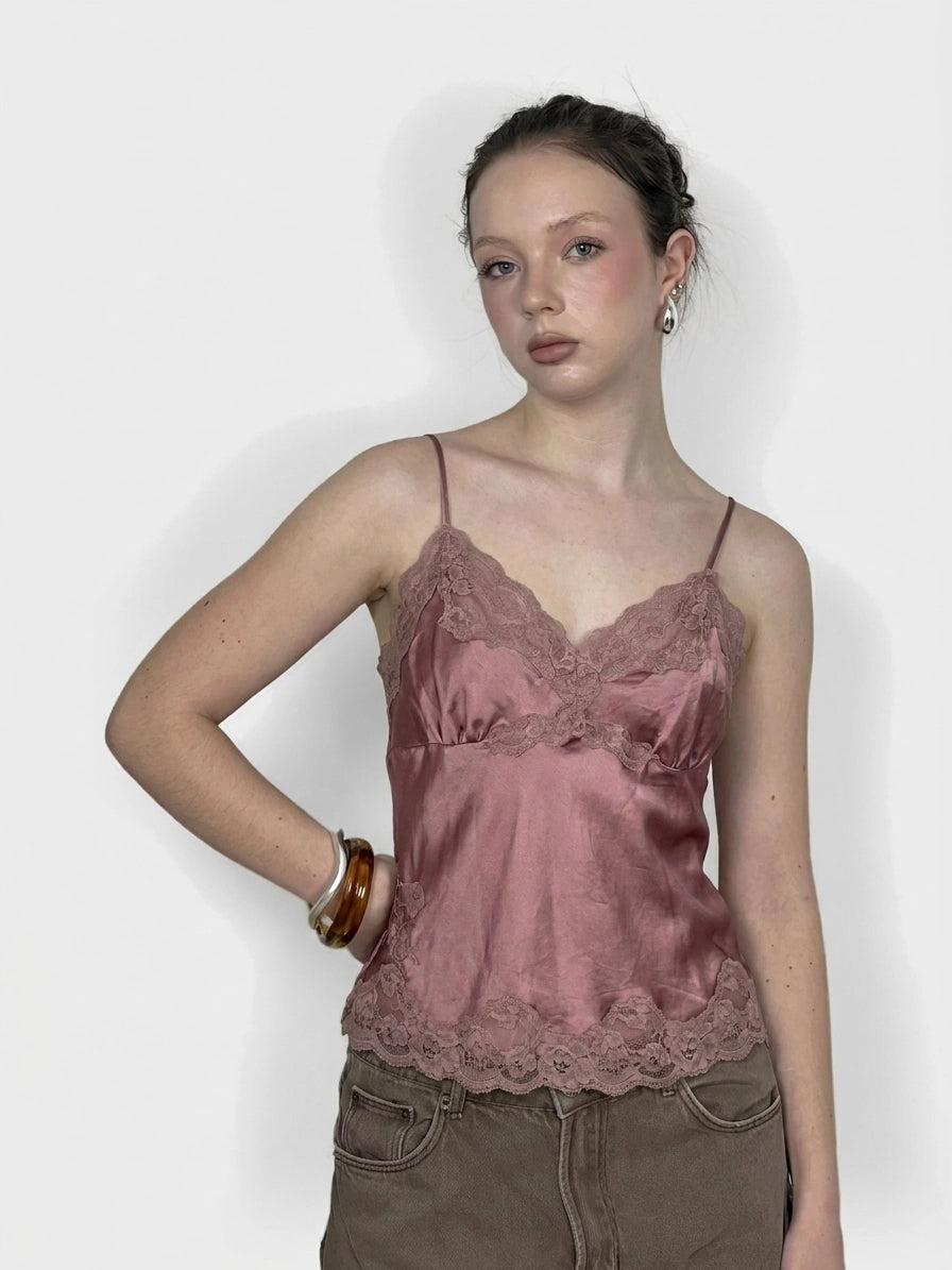 Front view of a pink lace-trimmed satin tank top.