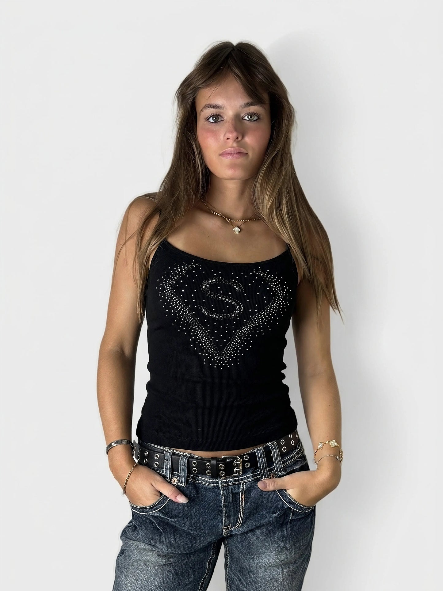 Black ribbed tank top with rhinestone detail, front view.