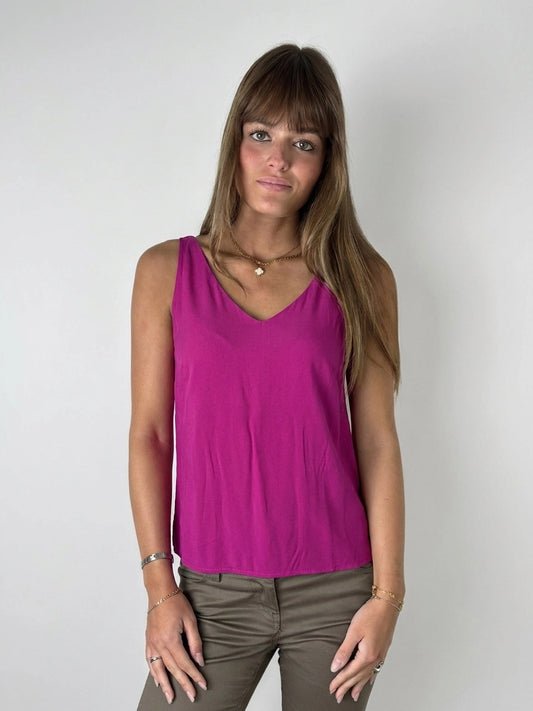 Front view of a pink sleeveless top with a v-neckline.