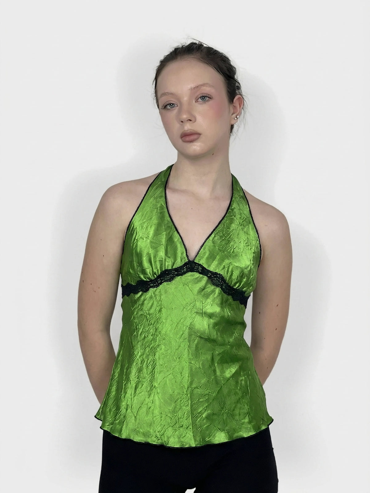 Green halter top with lace trim, front view.