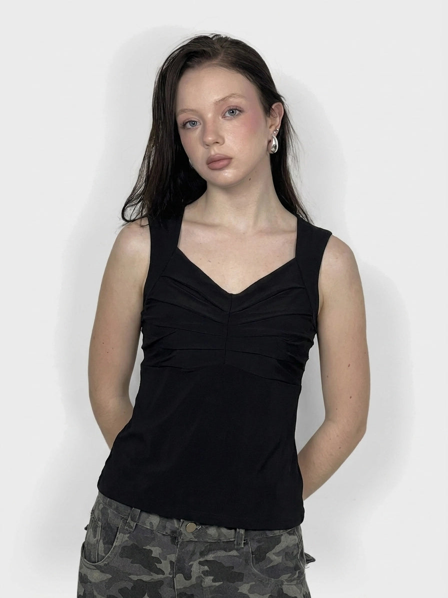 Women's black upper body top with pleated detail, front view.