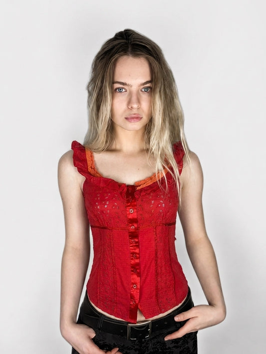 Red women's upper body top with ruffled straps and button front, front view.