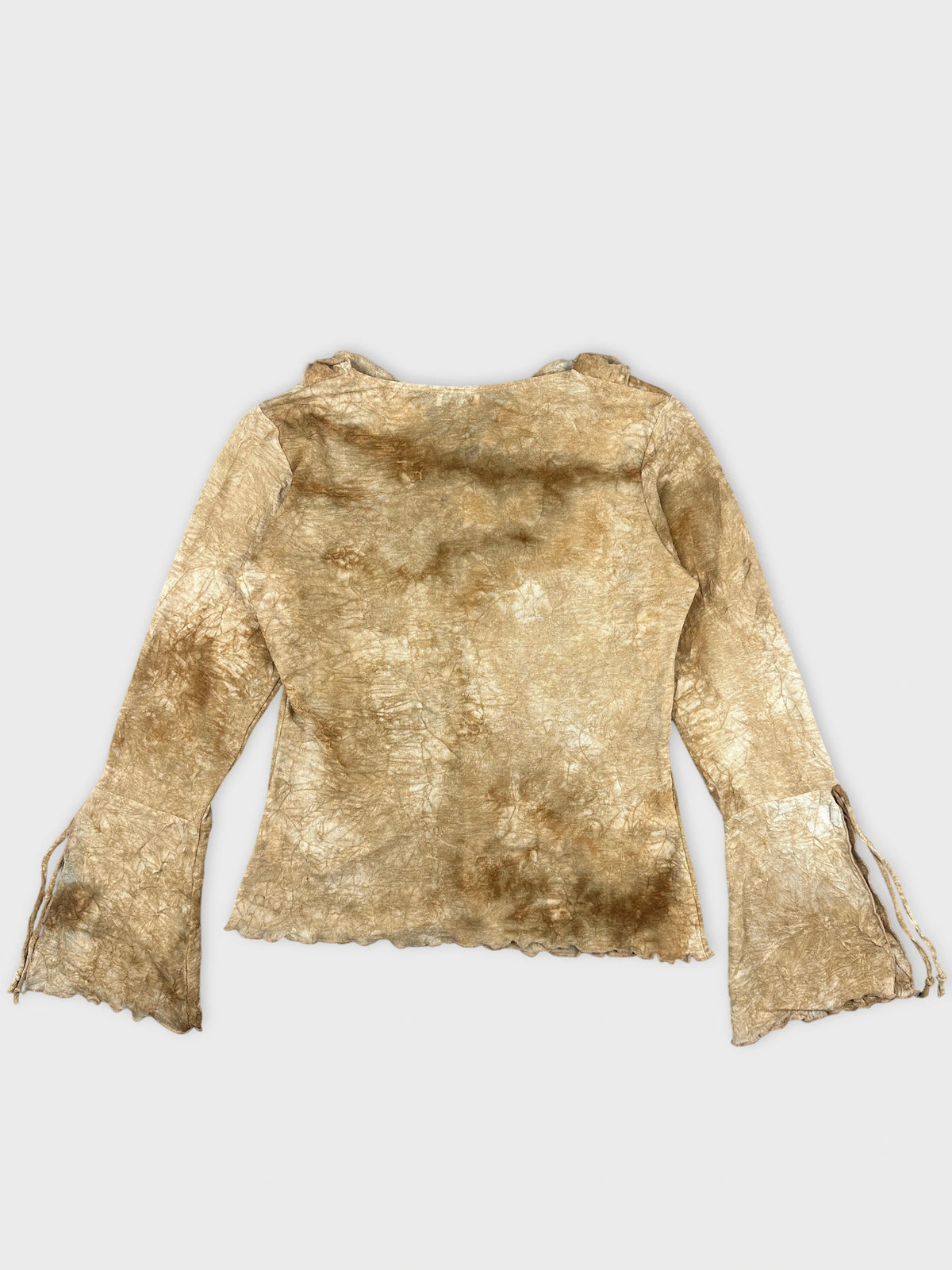 Back view of a long sleeve top in muted gold with scalloped trim.