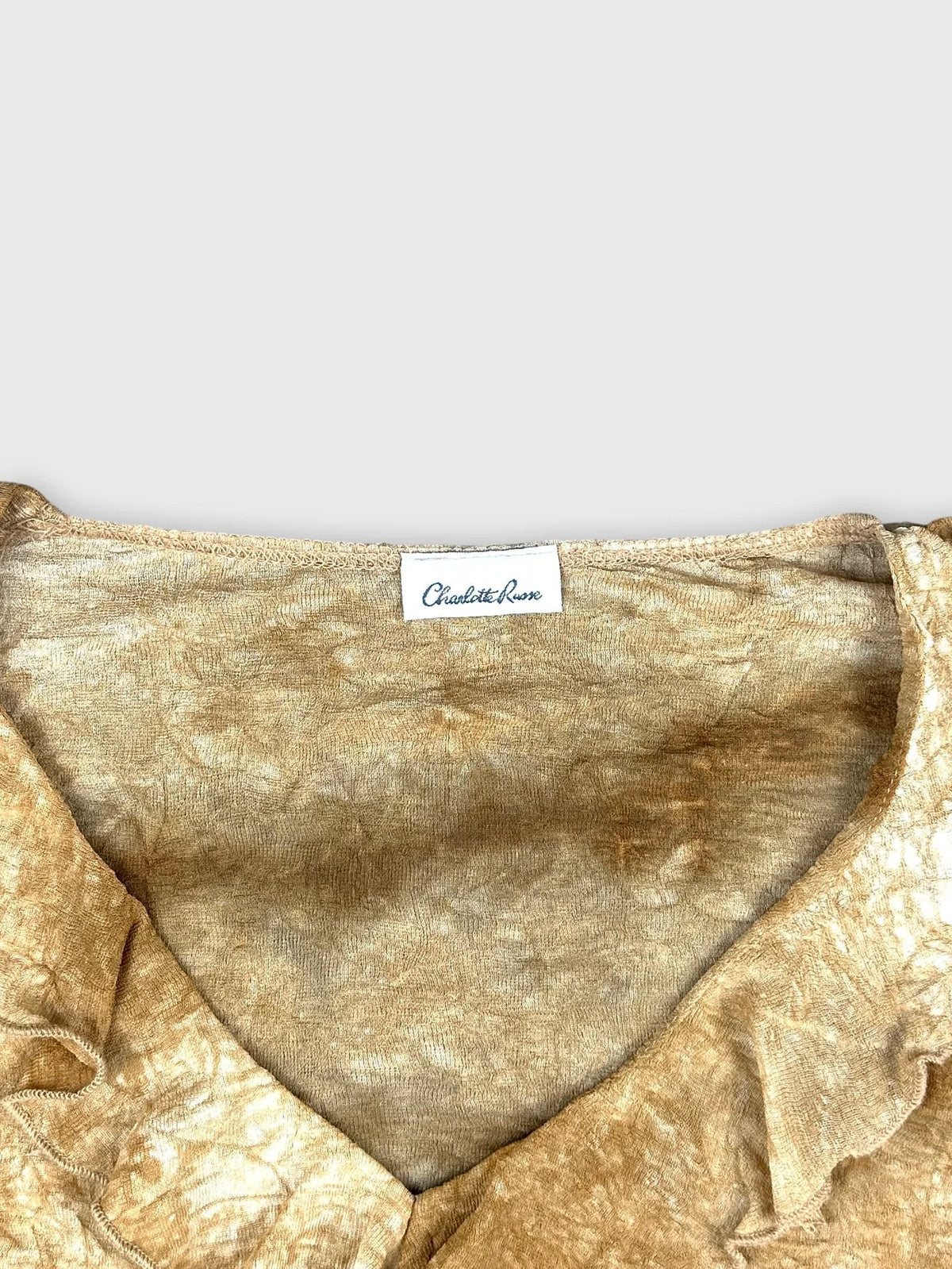 detail view of vintage upper long sleeve top in golden color with ruffled neckline