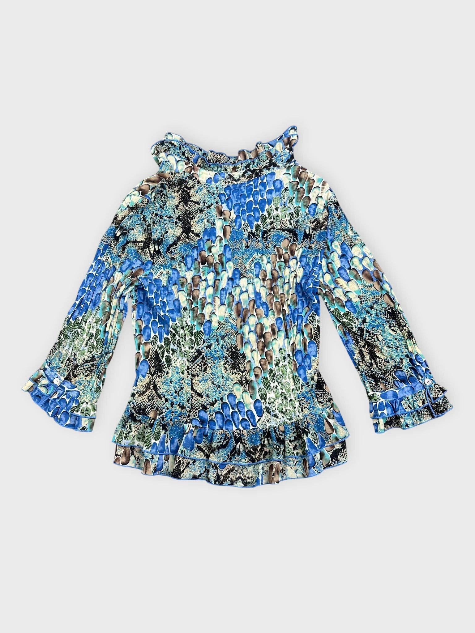 Back view of a blue patterned blouse with ruffled collar and sleeves.