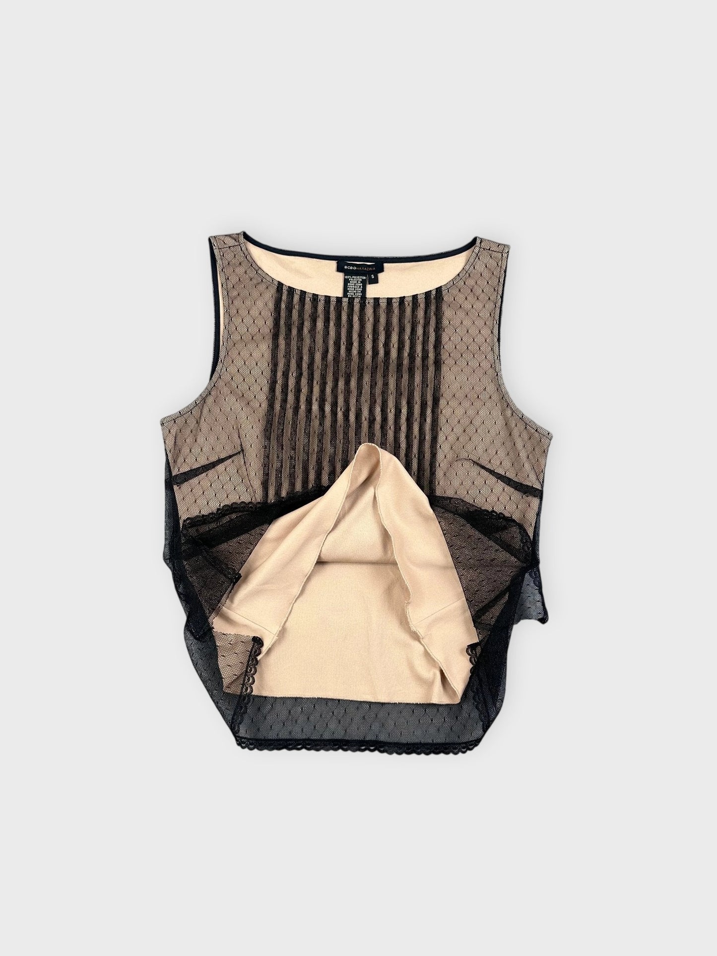Detail view of a sleeveless black mesh top with pleated pattern.