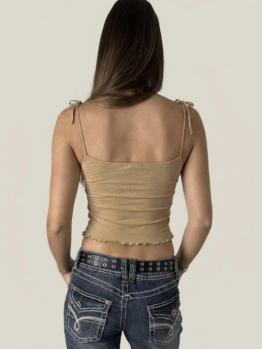 Back view of a beige ruffled crop top with playful edges.