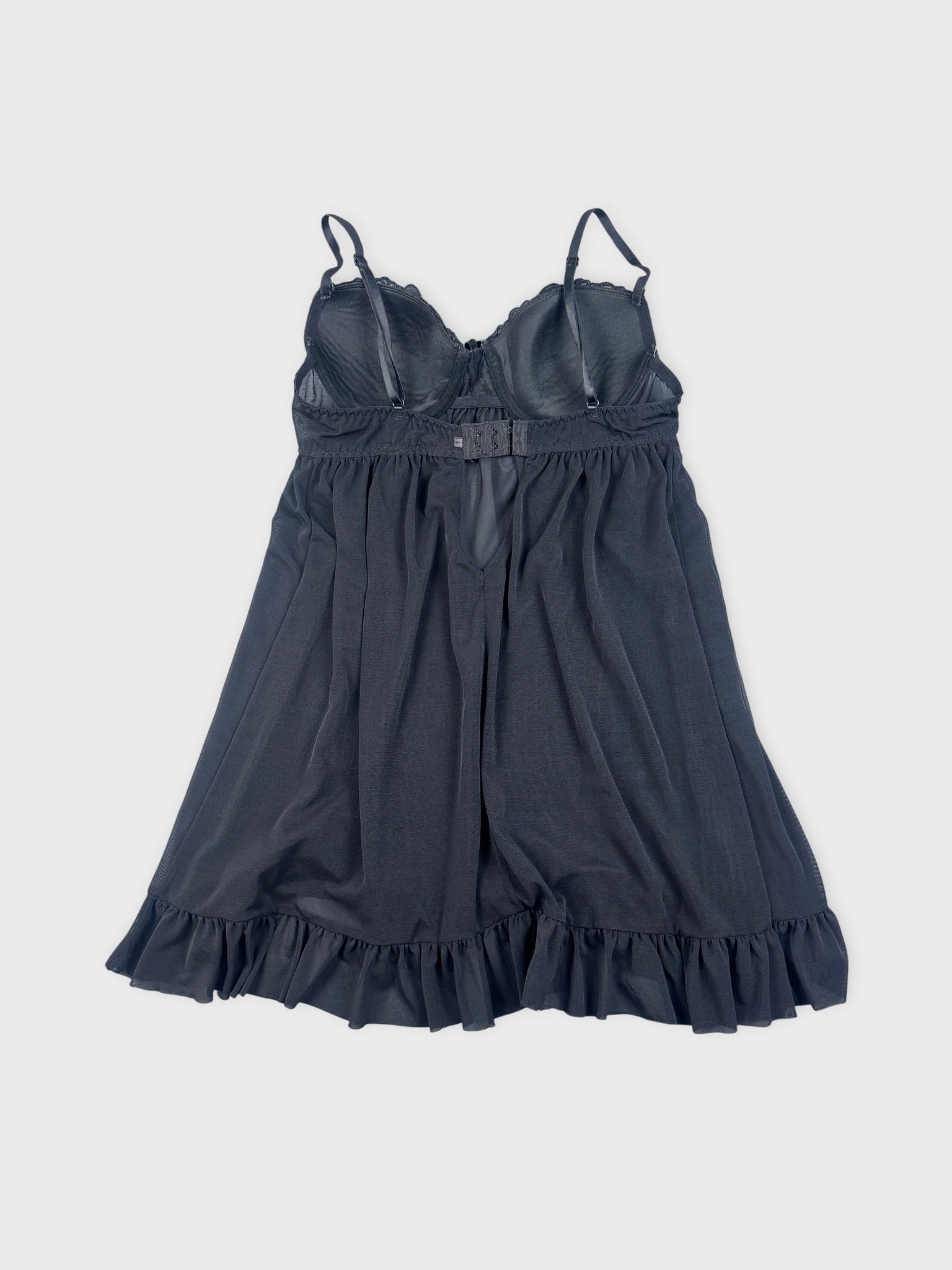Back view of a black camisole with a ruffled hemline.