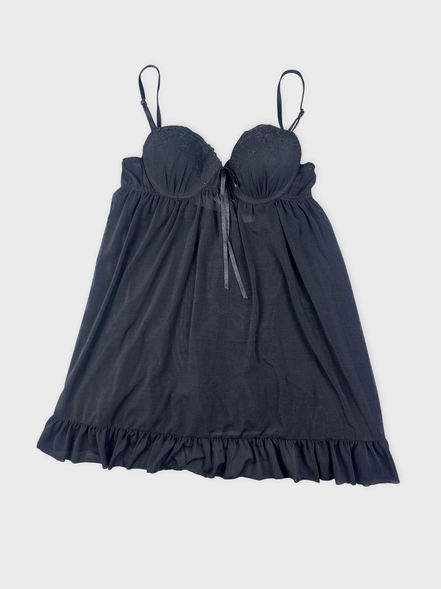 Black camisole with lace trim and flared shape detail view.
