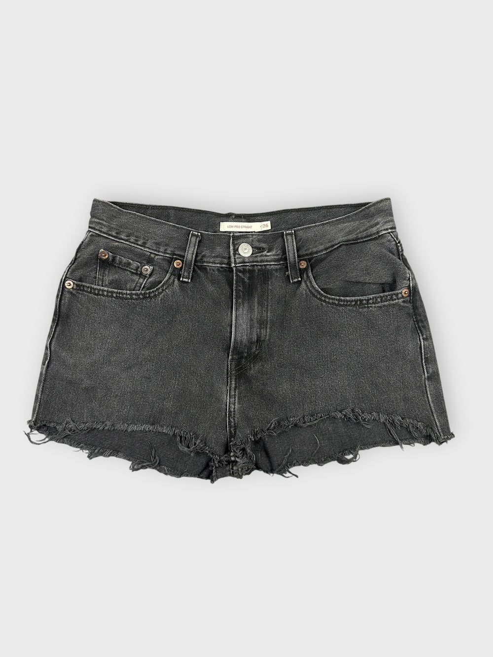 Black denim mini shorts with distressed hem front view.