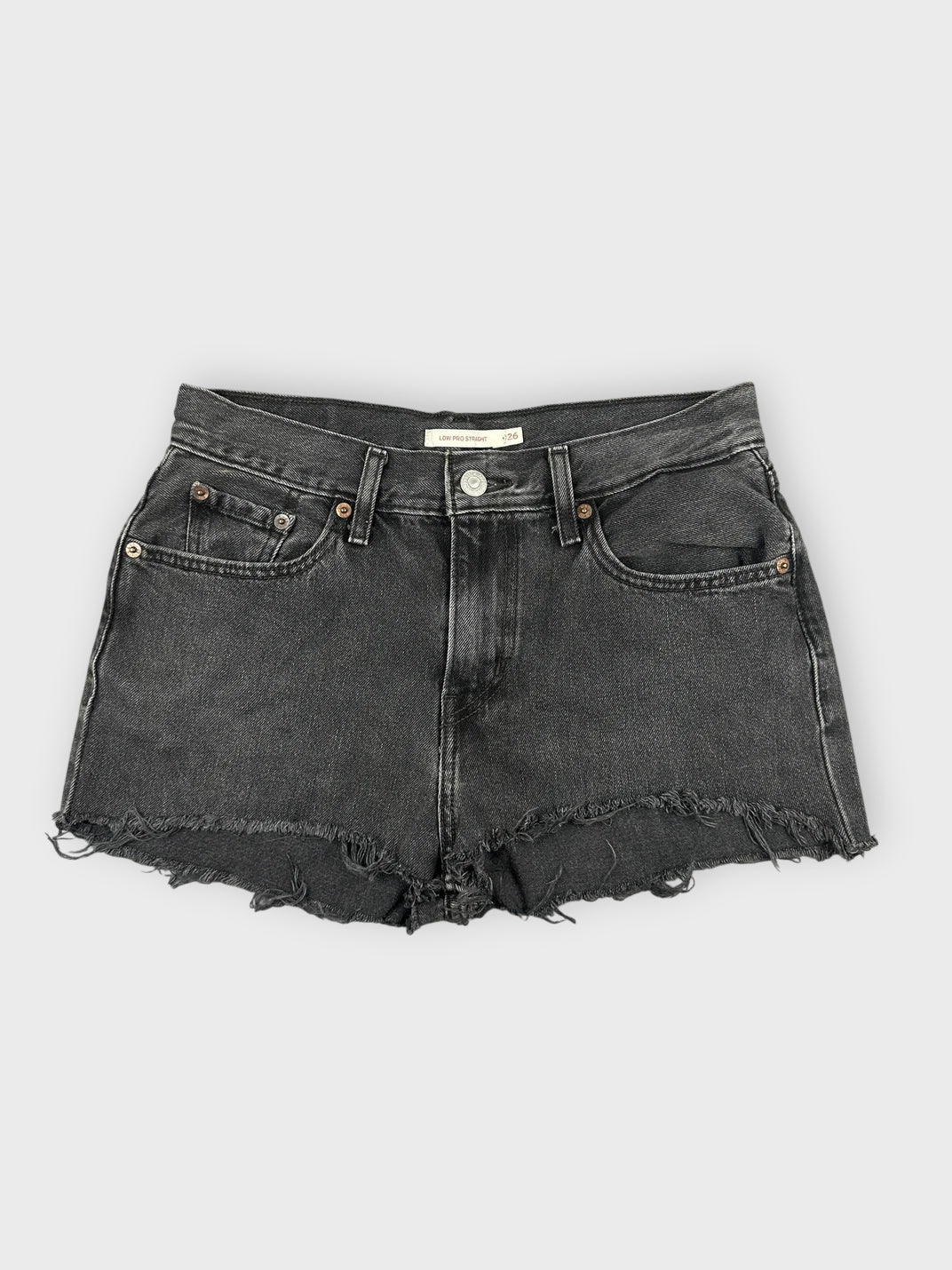 Black denim mini shorts with distressed hem front view.