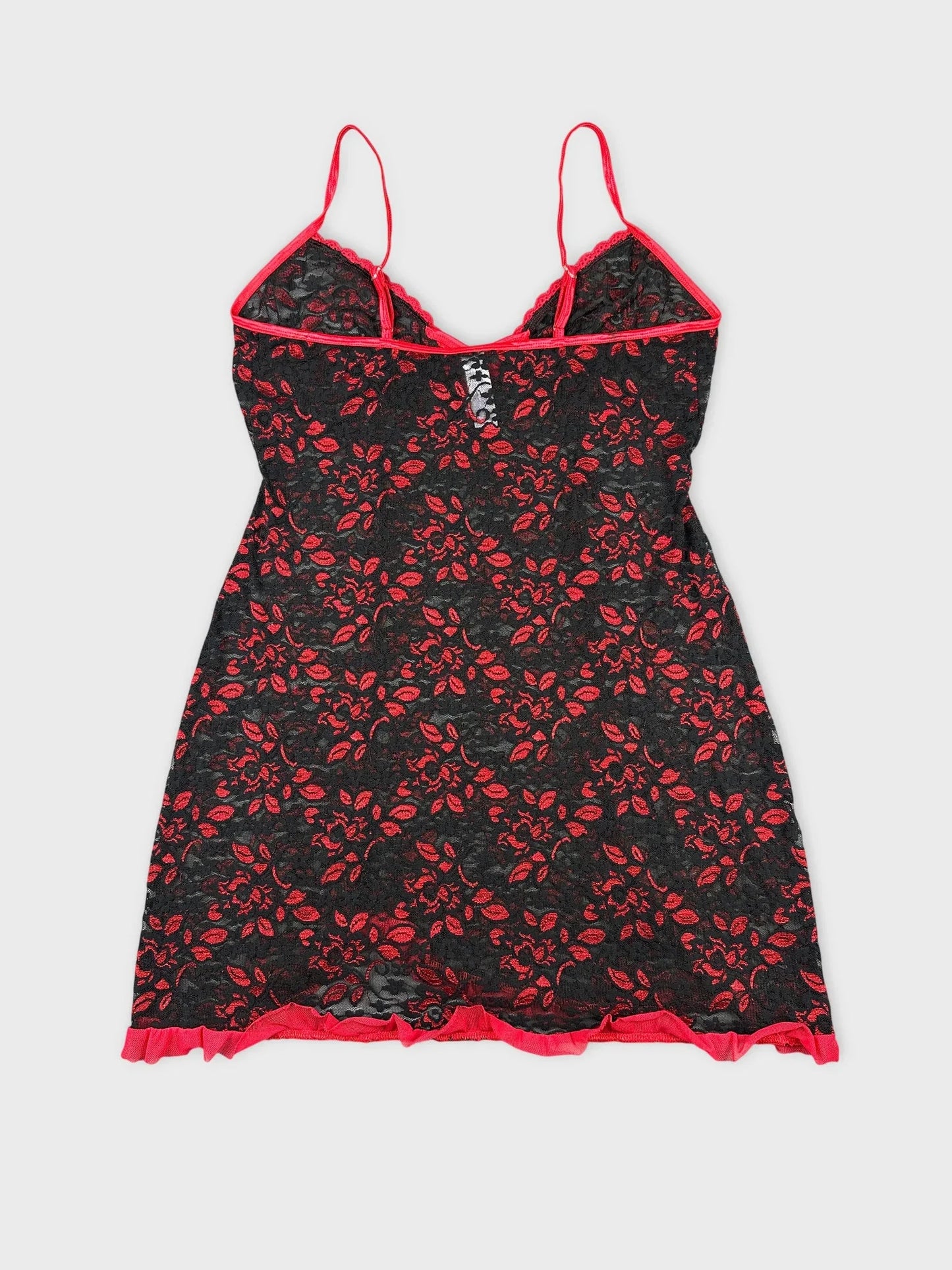 Back view of black floral lace top with red trim and adjustable straps.