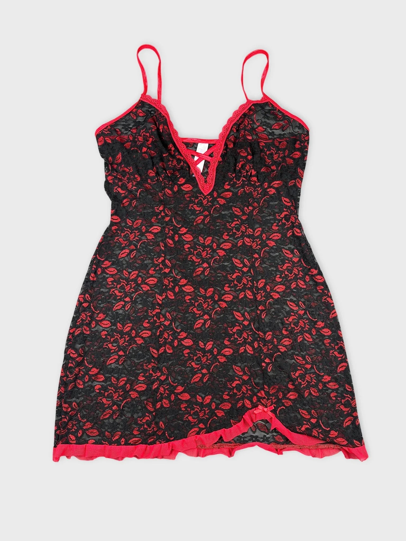 Front view of a black floral lace top with red trim and straps.