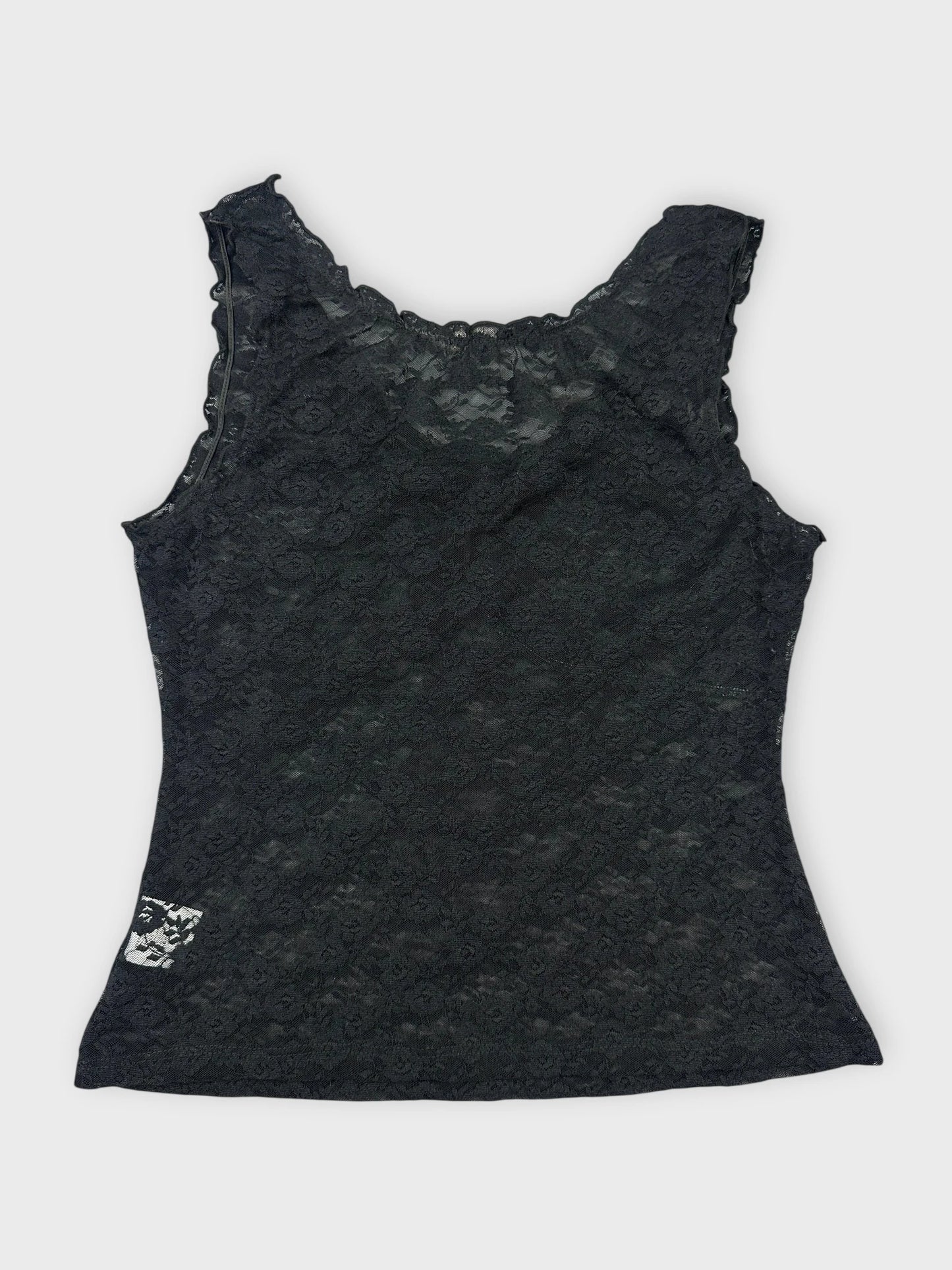 Back view of black lace top featuring floral details and scalloped trim.