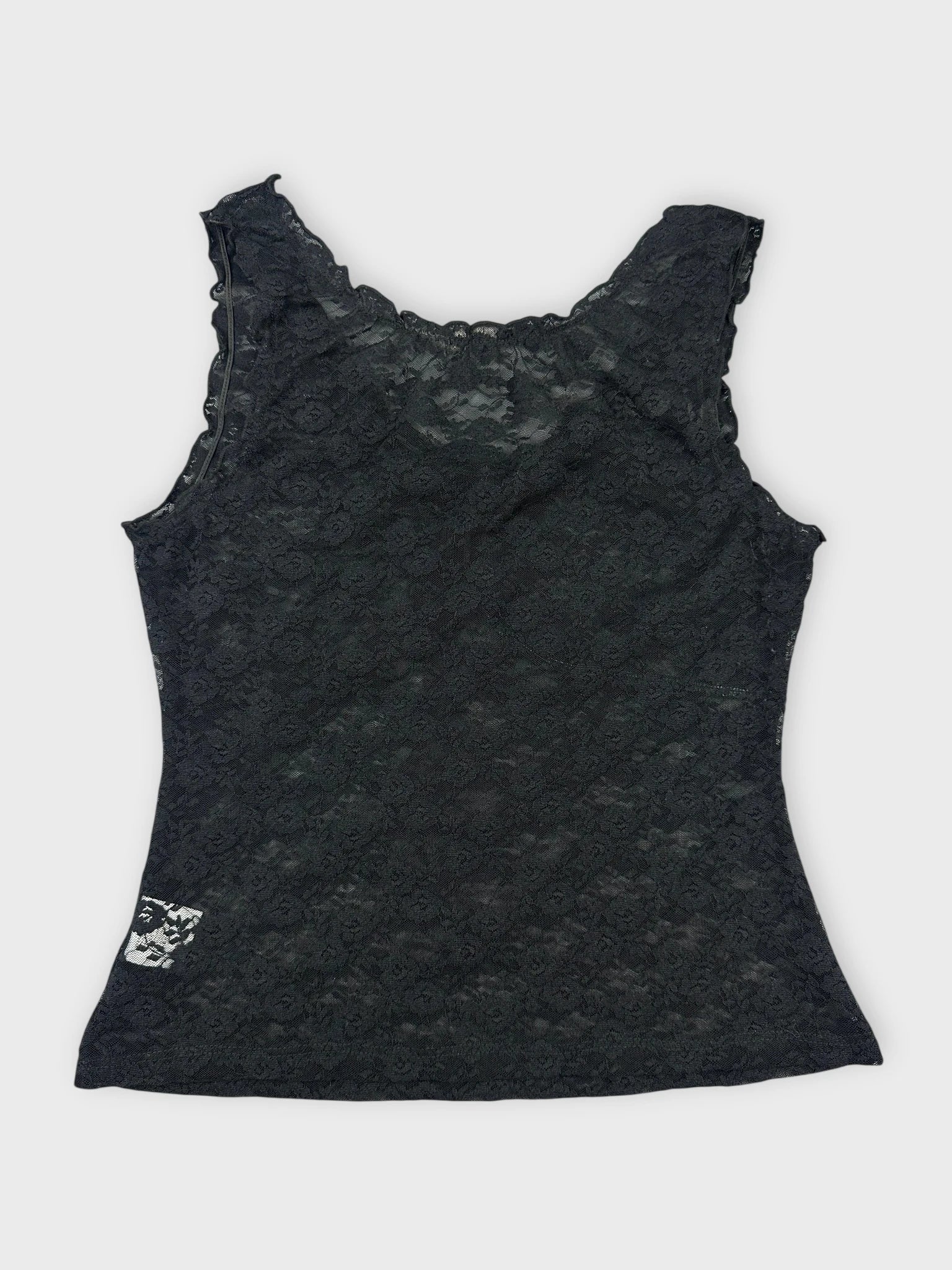 Back view of black lace top featuring floral details and scalloped trim.