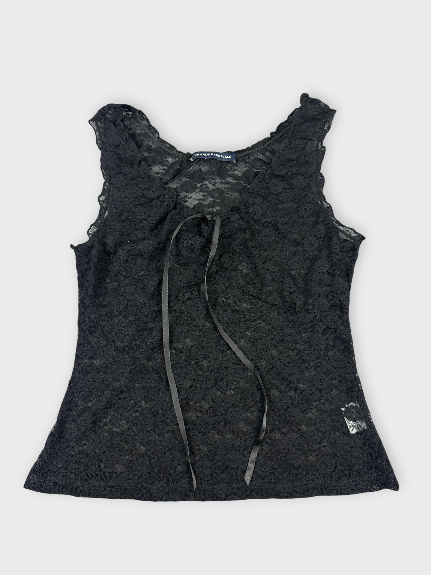 Black lace top with floral details front view featuring a tie and delicate pattern.