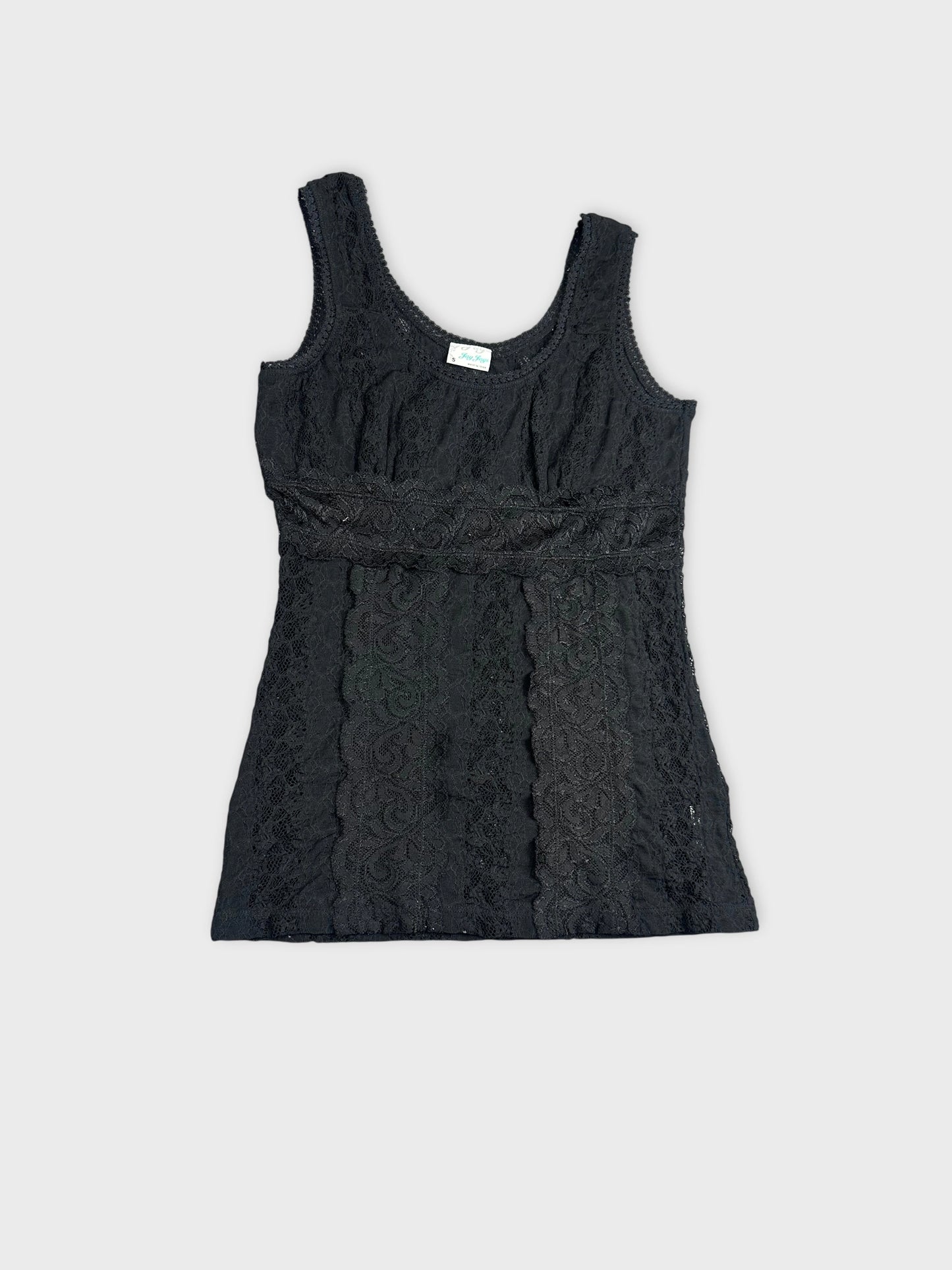 Detail view of a black lace top featuring intricate patterns.