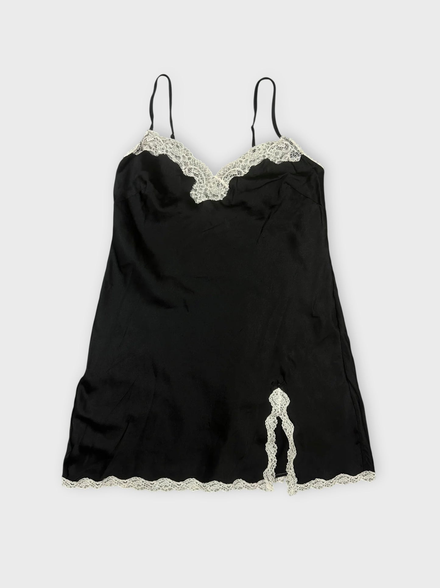 Black satin cami with lace trim front view showcasing delicate detailing at the hem.
