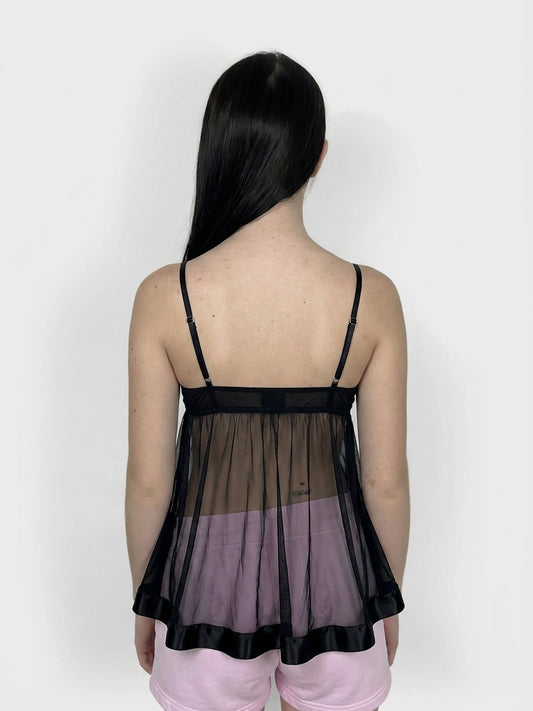 Back view of a black sheer bralette dress with ribbon ties, featuring lace trim.