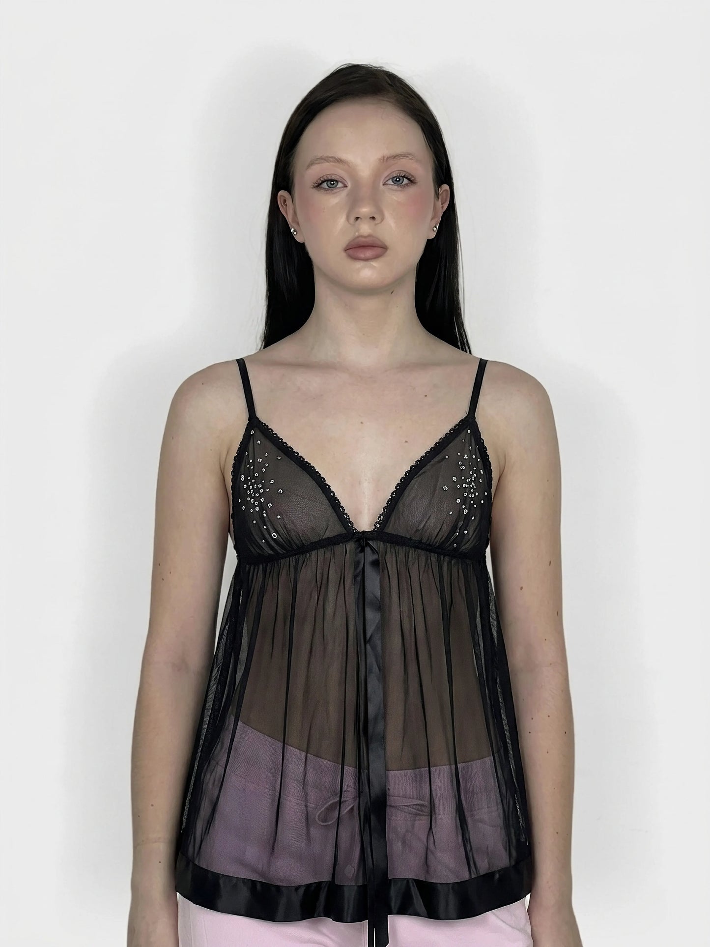 Black sheer bralette dress with ribbon ties, front view, featuring a v-neck and embellishments.
