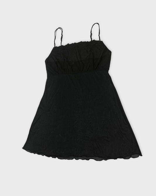 Black sheer slip dress with spaghetti straps front view featuring a relaxed fit.