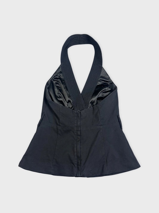 Back view of a black sleeveless blazer vest featuring a flared hem.