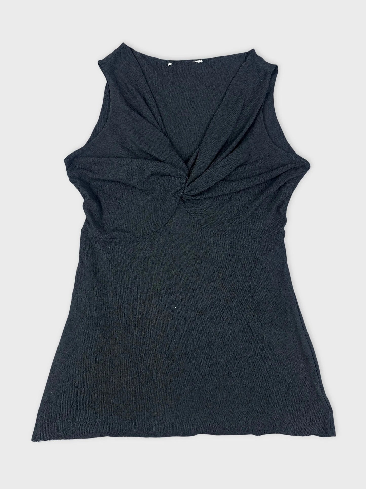 Black sleeveless top with twist detail front view.