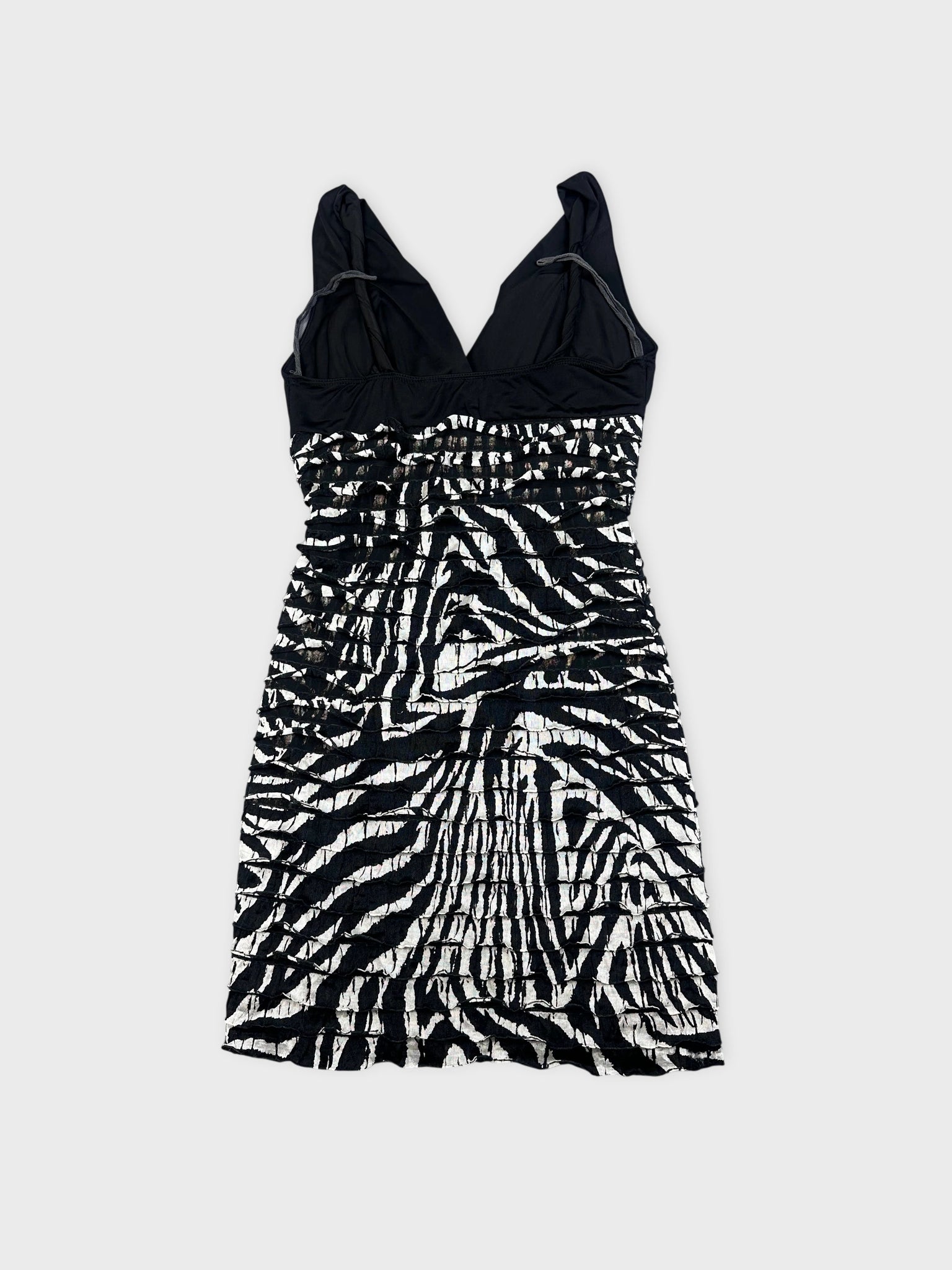 Back view of a black and white striped mini dress with gathered texture.