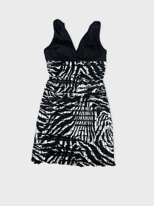 front view of a black and white zebra striped mini dress with gathered details