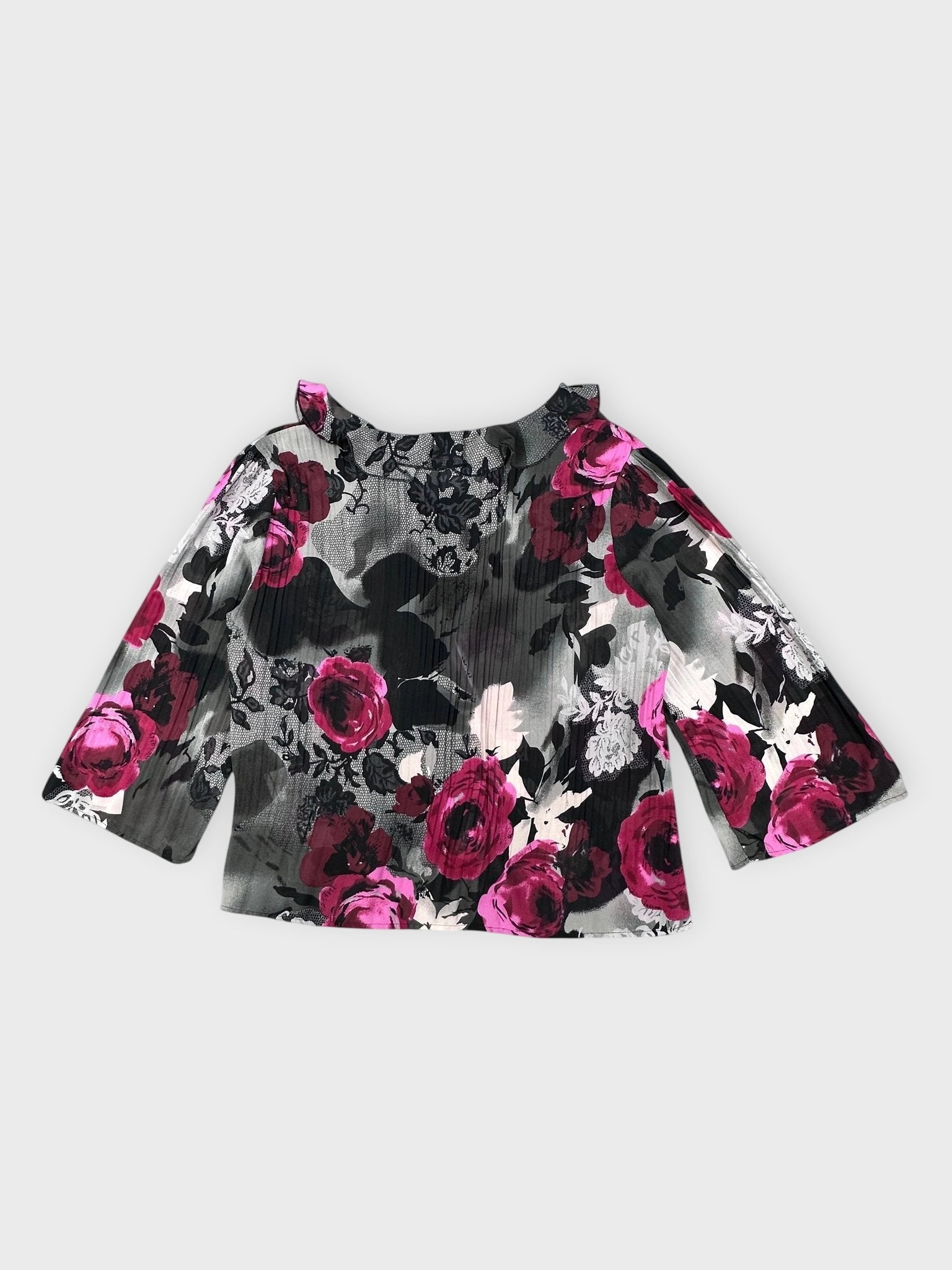 Back view of a blouse featuring black and pink floral print