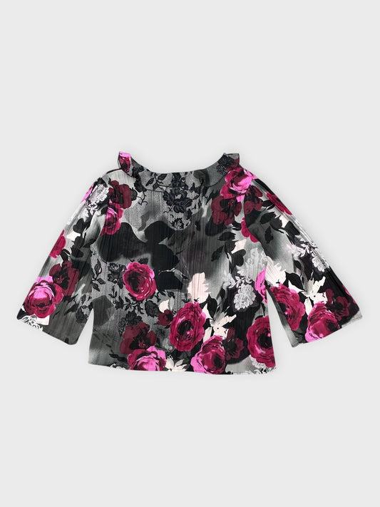 Back view of a blouse featuring black and pink floral print