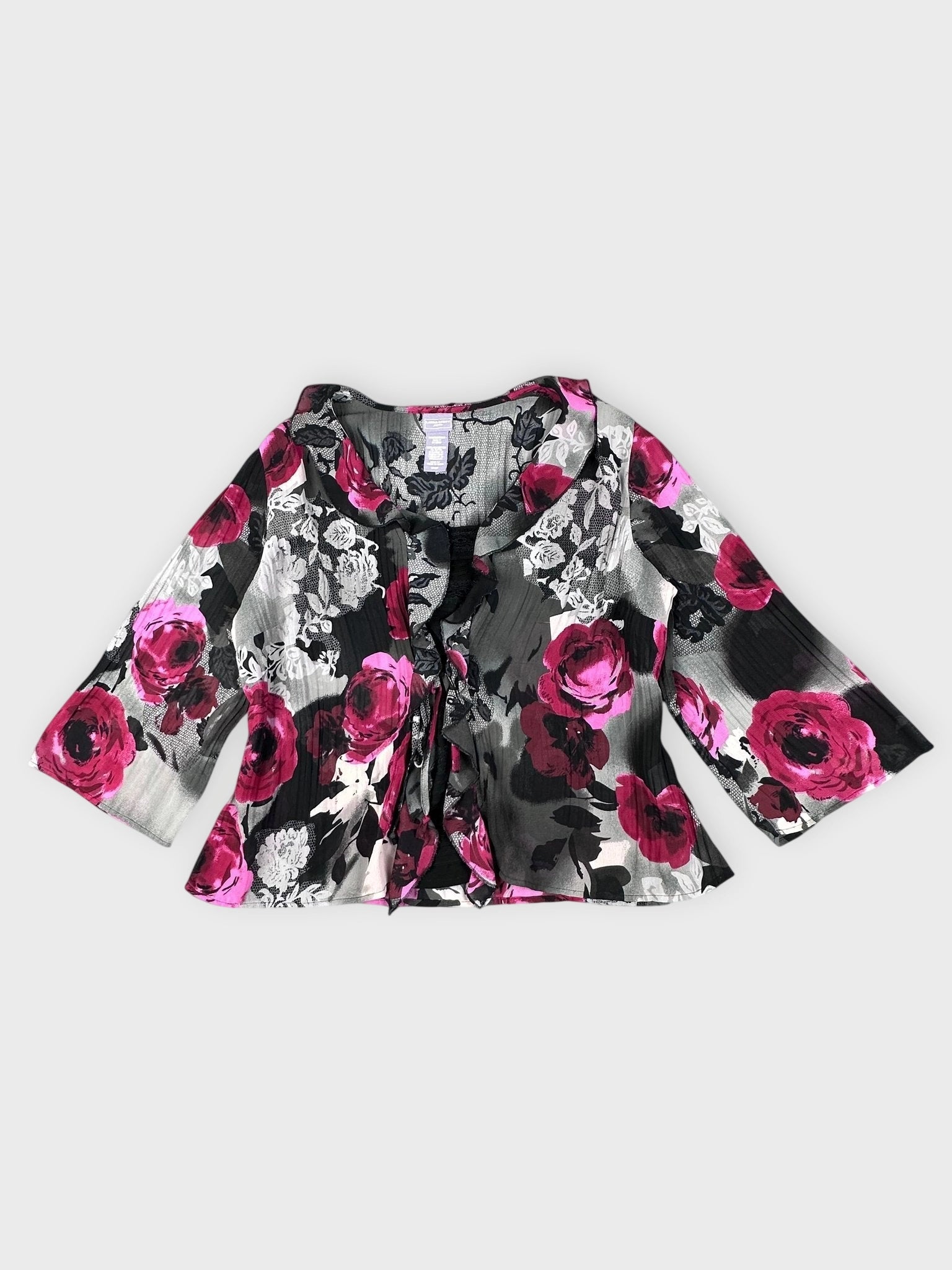 Front view of a black blouse with pink floral pattern and tie detail.