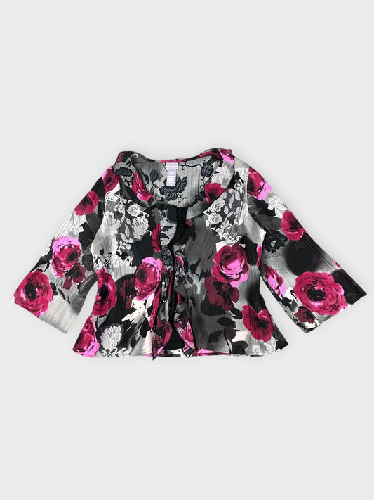 Front view of a black blouse with pink floral pattern and tie detail.