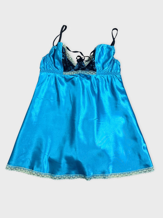 Back view of a blue satin baby doll dress with lace trim.