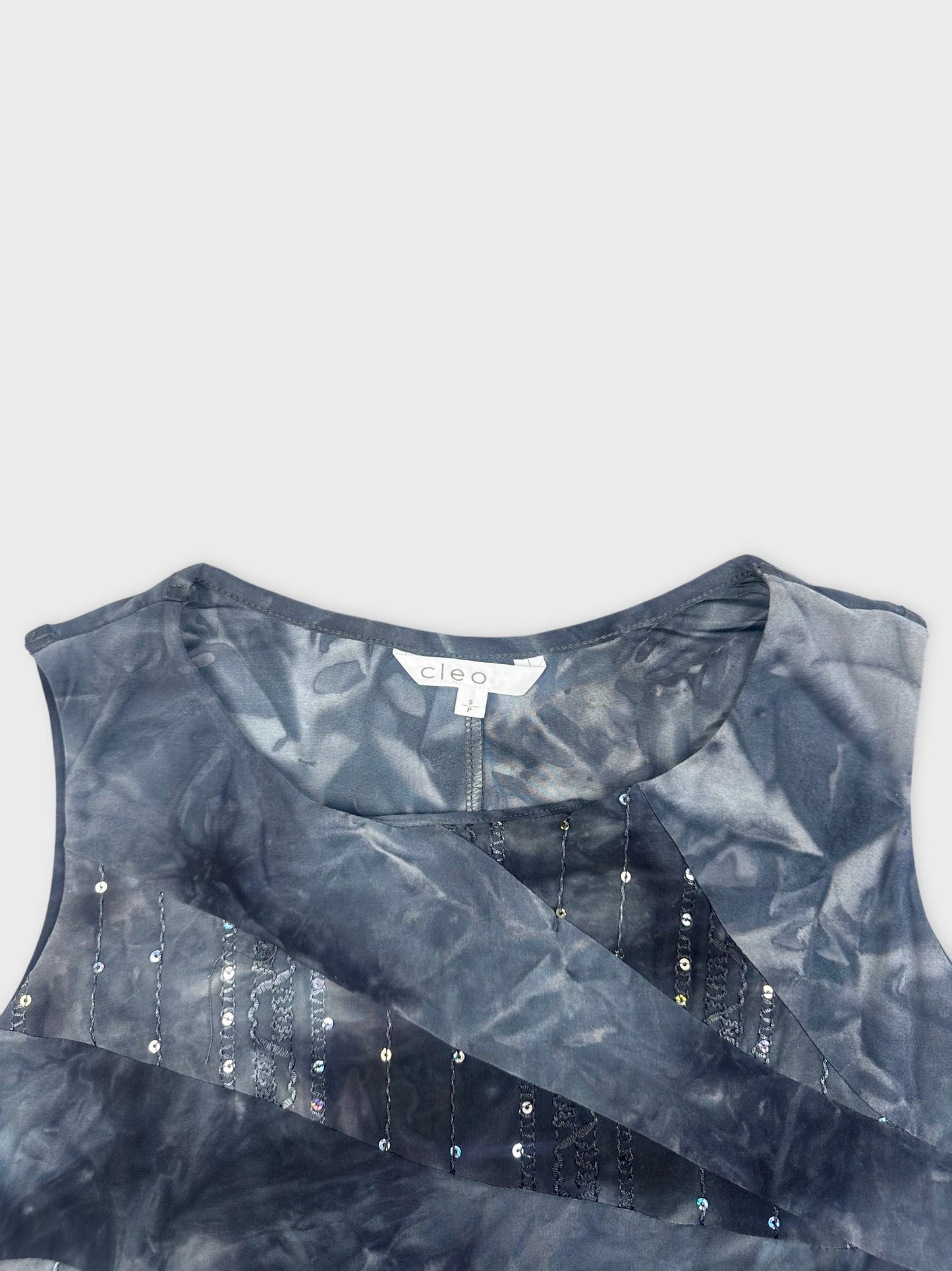 Detail view of blue tie dye sleeveless shirt with sequined embellishments.