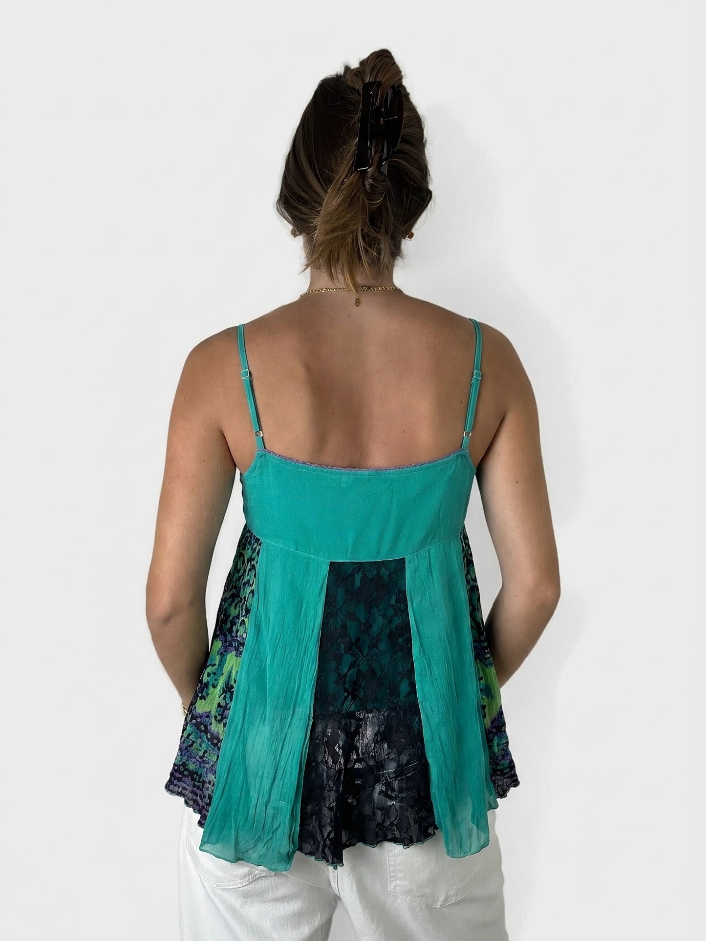 Back view of a turquoise bohemian tunic top with layered lace detail.