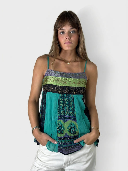 Front view of a teal layered tunic top with colorful pattern and spaghetti straps.
