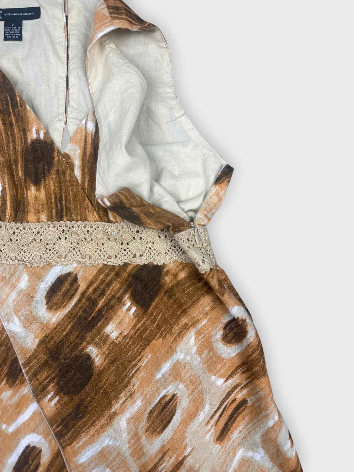 Detail view of brown boho chic wrap top with lace trim.