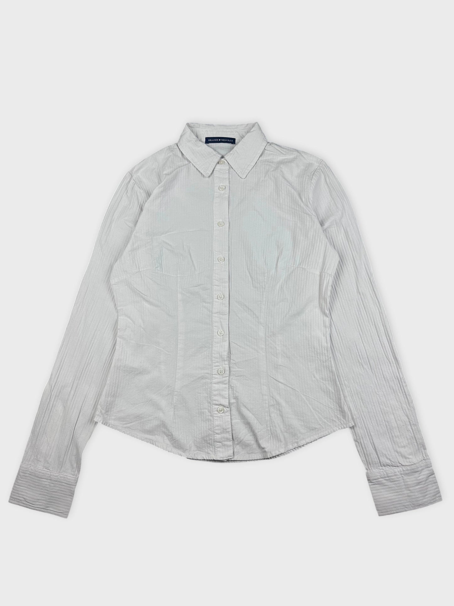 Detail view of a white striped button-down shirt with a collared neckline.