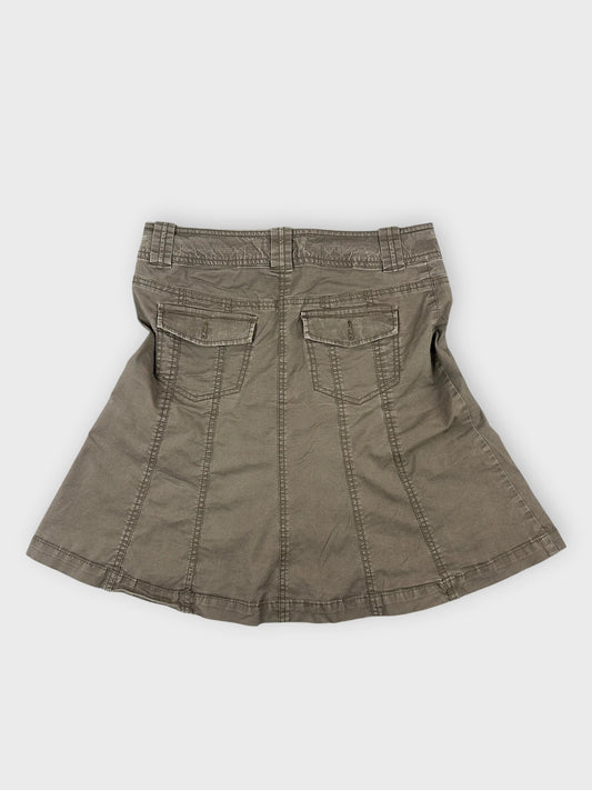 Back view of a brown cotton mini skirt featuring two back pockets.