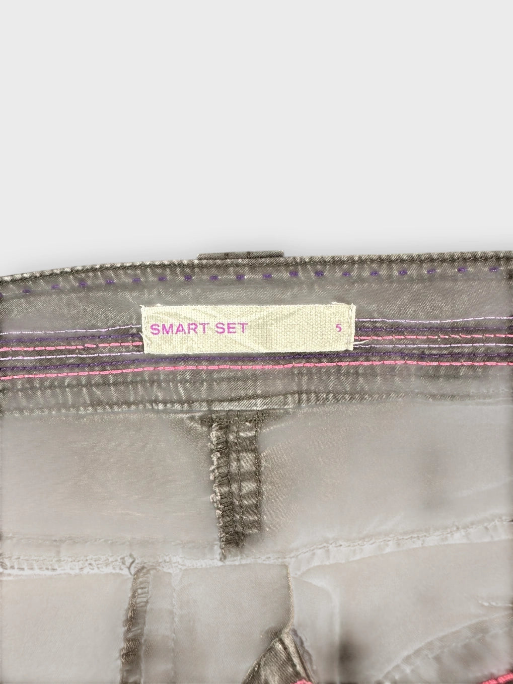 Detail view of a brown cotton mini skirt with pocket stitching.