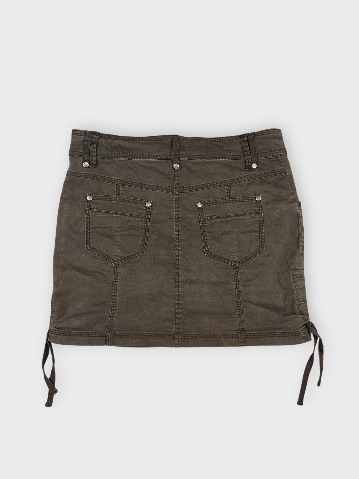 Brown mini skirt with side drawstrings back view featuring pockets and stitching details.