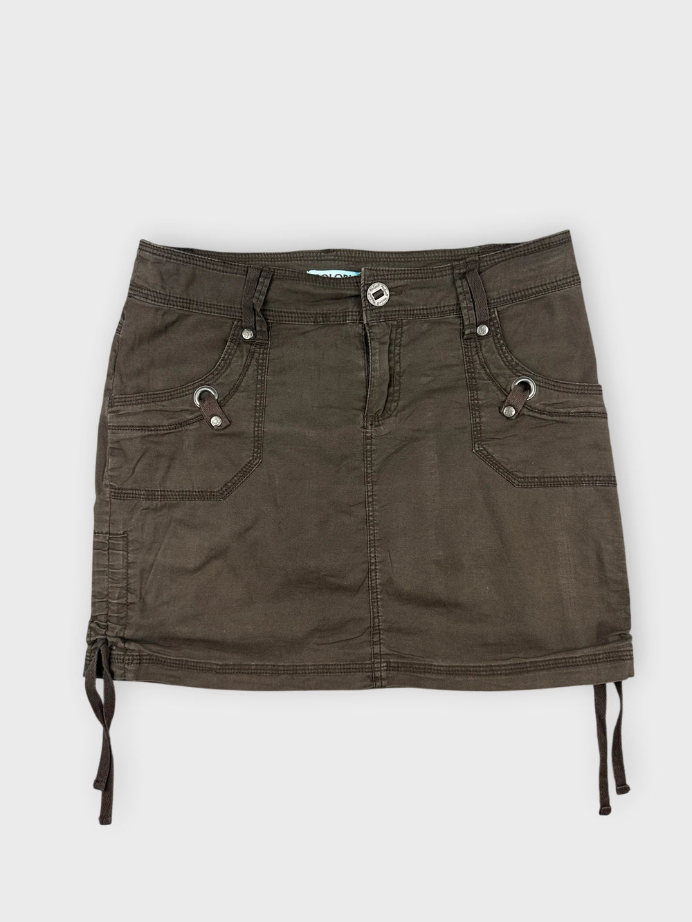 Front view of a brown mini skirt with side drawstrings and pockets