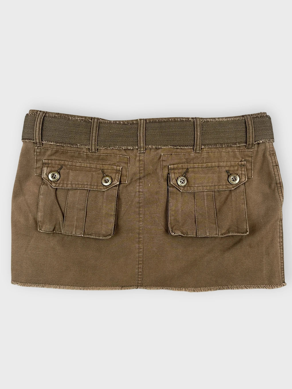 Back view of brown mini skirt featuring unique belt detail and two back pockets.