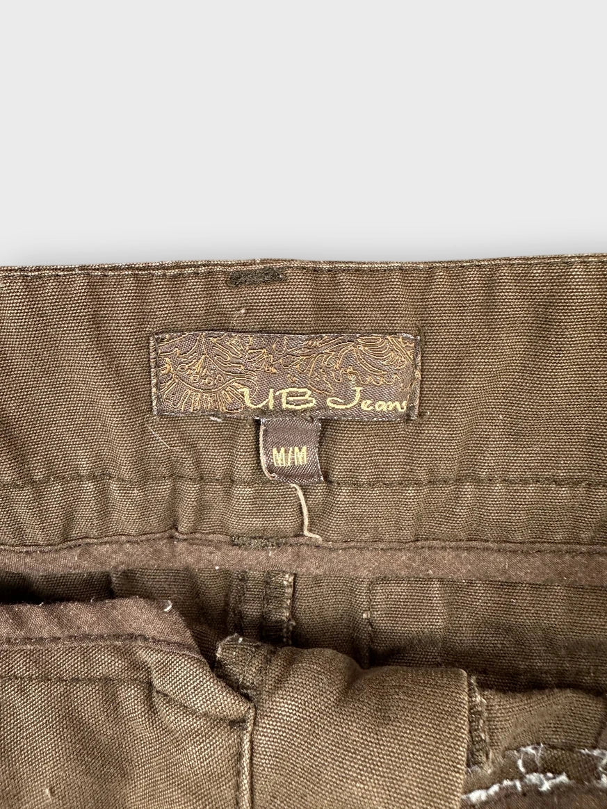 Detail view of brown mini skirt showing unique belt detail and tag.